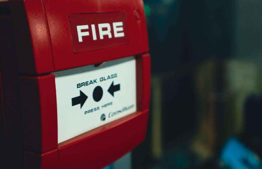 Image of red fire alarm system trigger.