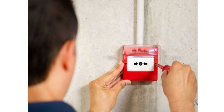 Man installing a fire alarm